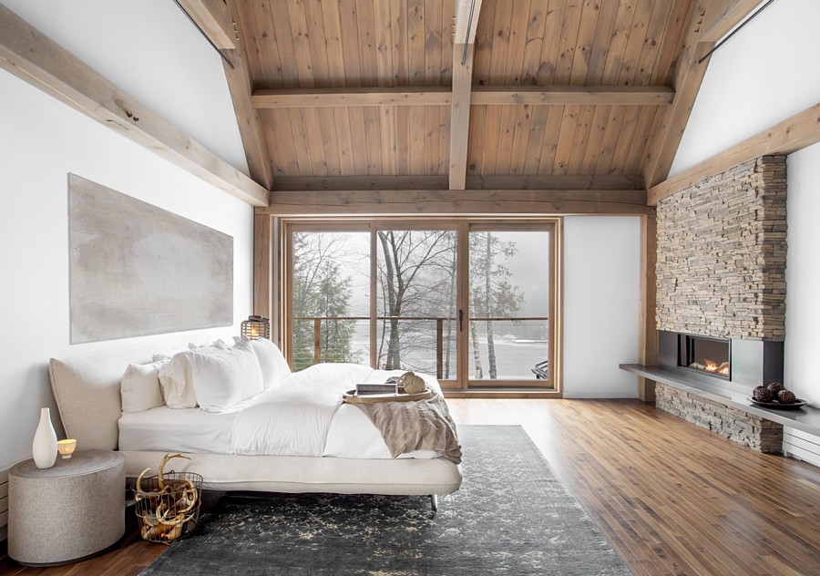 A Biophilic Bedroom Design with Views, a Wood Paneled Ceiling, and a Fireplace with Dry-Stack Stone