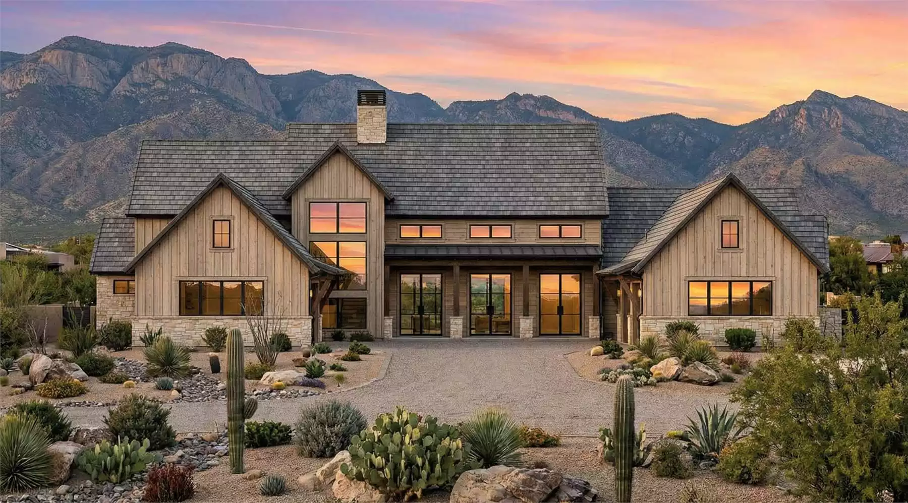 4 bedroom modern farmhouse with wood siding, large windows, and mountain views featuring expansive outdoor living spaces and desert landscaping